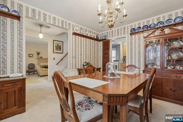 a kitchen with stainless steel appliances granite countertop a stove a sink and white cabinets