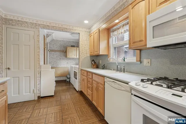 a spacious bedroom with a bed and a tv on the dresser