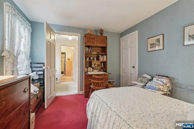 a bedroom with a bed and a table in it