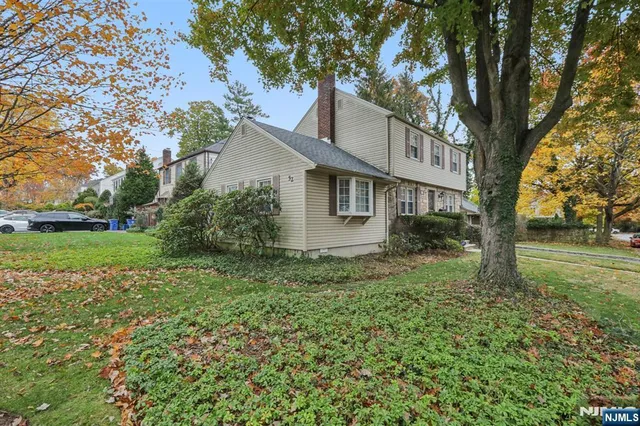 a view of a house with yard and a tree
