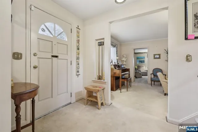 a view of a livingroom with furniture and a table chair