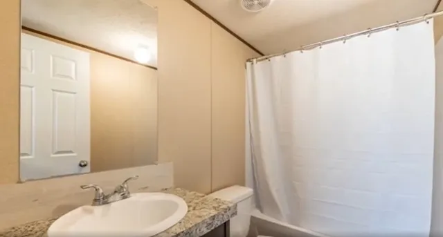 a bathroom with a mirror and a shower