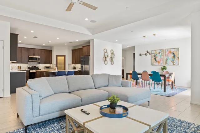 a living room with furniture kitchen view and a dining table