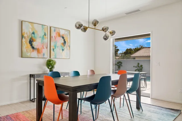a view of a dining room with furniture wooden floor and a chandelier