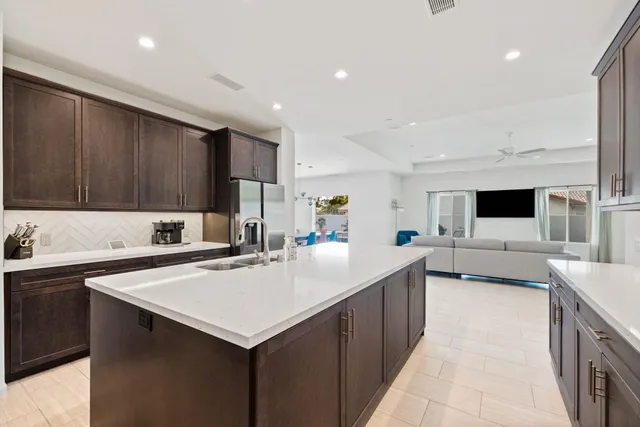 a kitchen with a sink refrigerator and cabinets