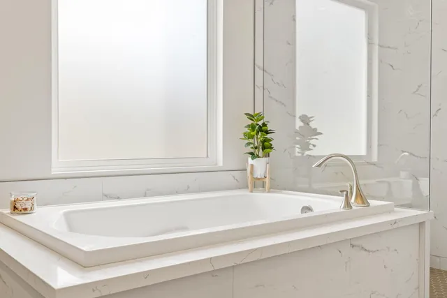 a bathroom with a bathtub and sink
