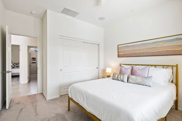 a bedroom with a bed and a view of bathroom