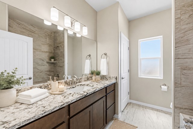 9818 North Cyrus Road Kingman, AZ 86401 - Photo 17 of 42 a bathroom with a granite countertop sink and a mirror