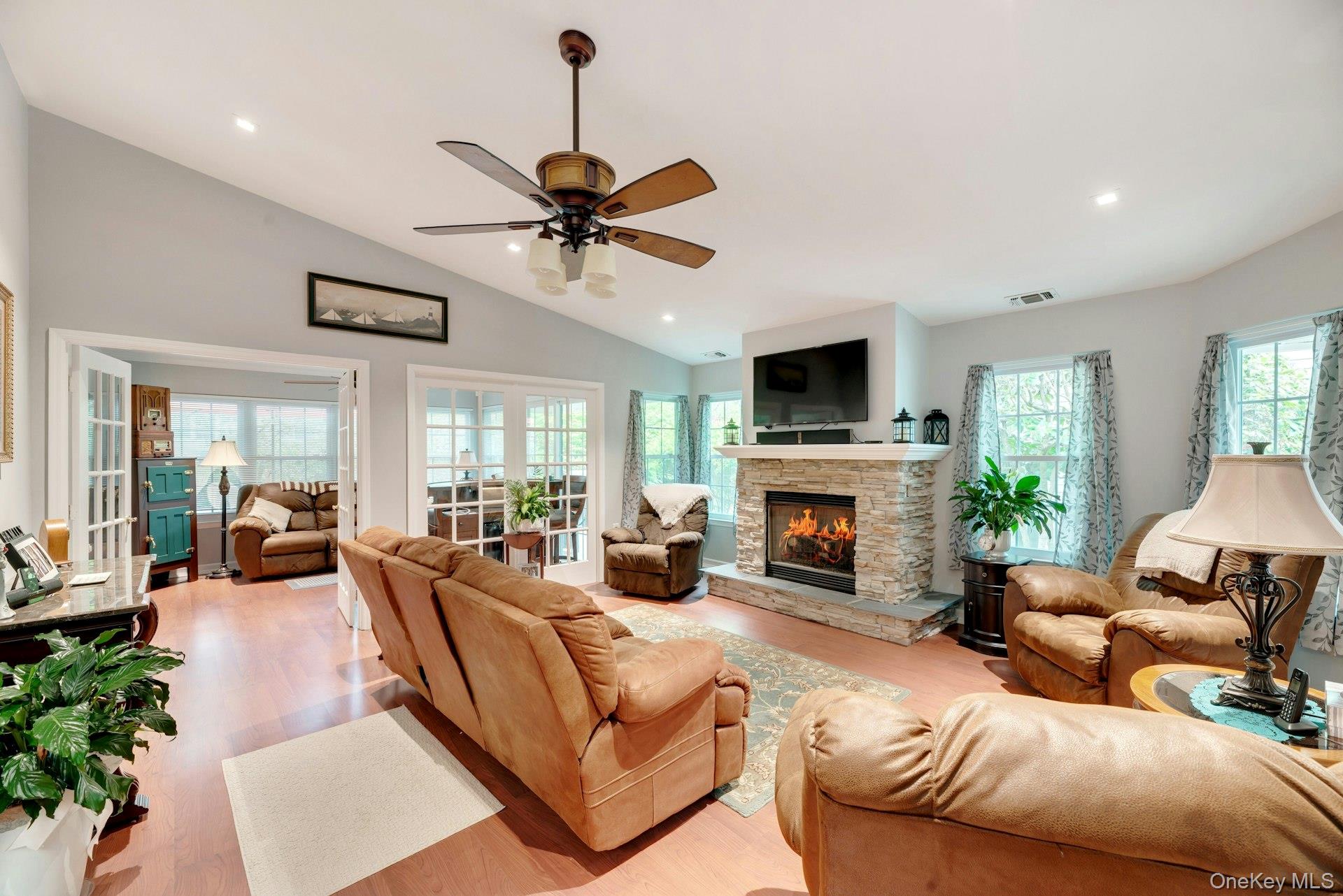 104 Glen Drive Ridge, NY 11961 - Photo 6 of 25 a living room with furniture a fireplace and a flat screen tv