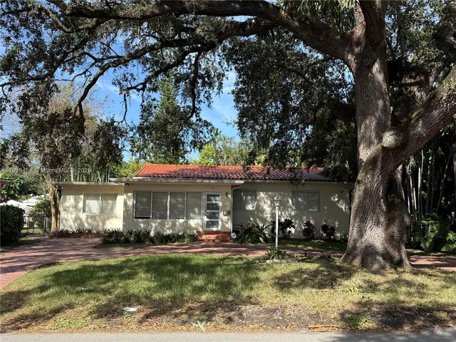 a view of a house with backyard porch and sitting area