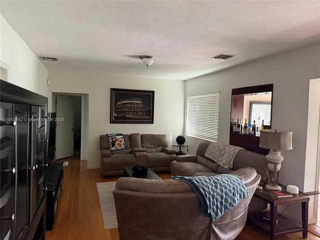 a living room with furniture a lamp and a window