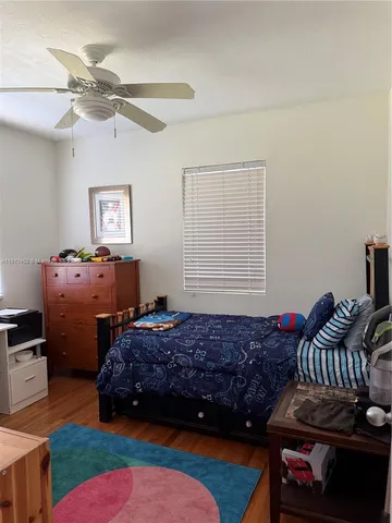 a bedroom with bed and a window