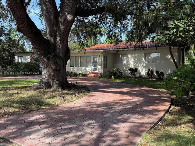 a view of a tree in front of a house