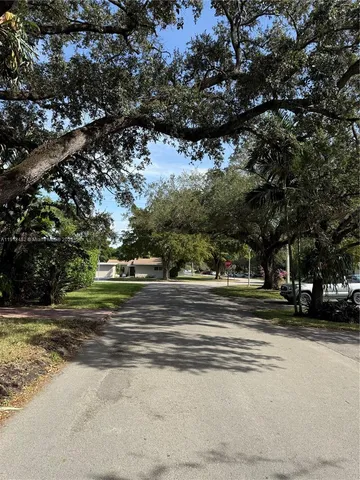 a view of park with large trees