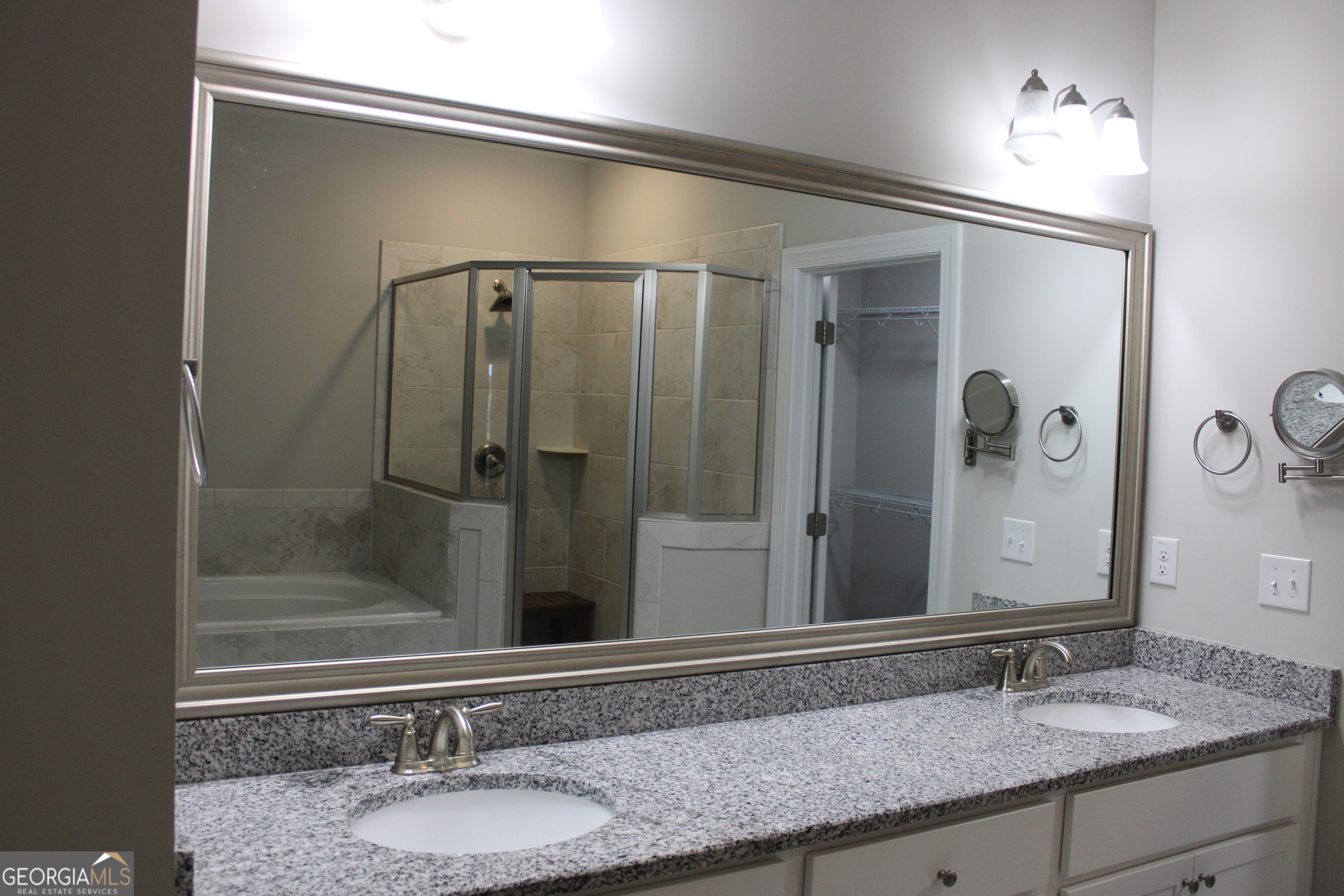 40 Owens Path Senoia, GA 30276 - Photo 11 of 21 a bathroom with a granite countertop sink a mirror and shower