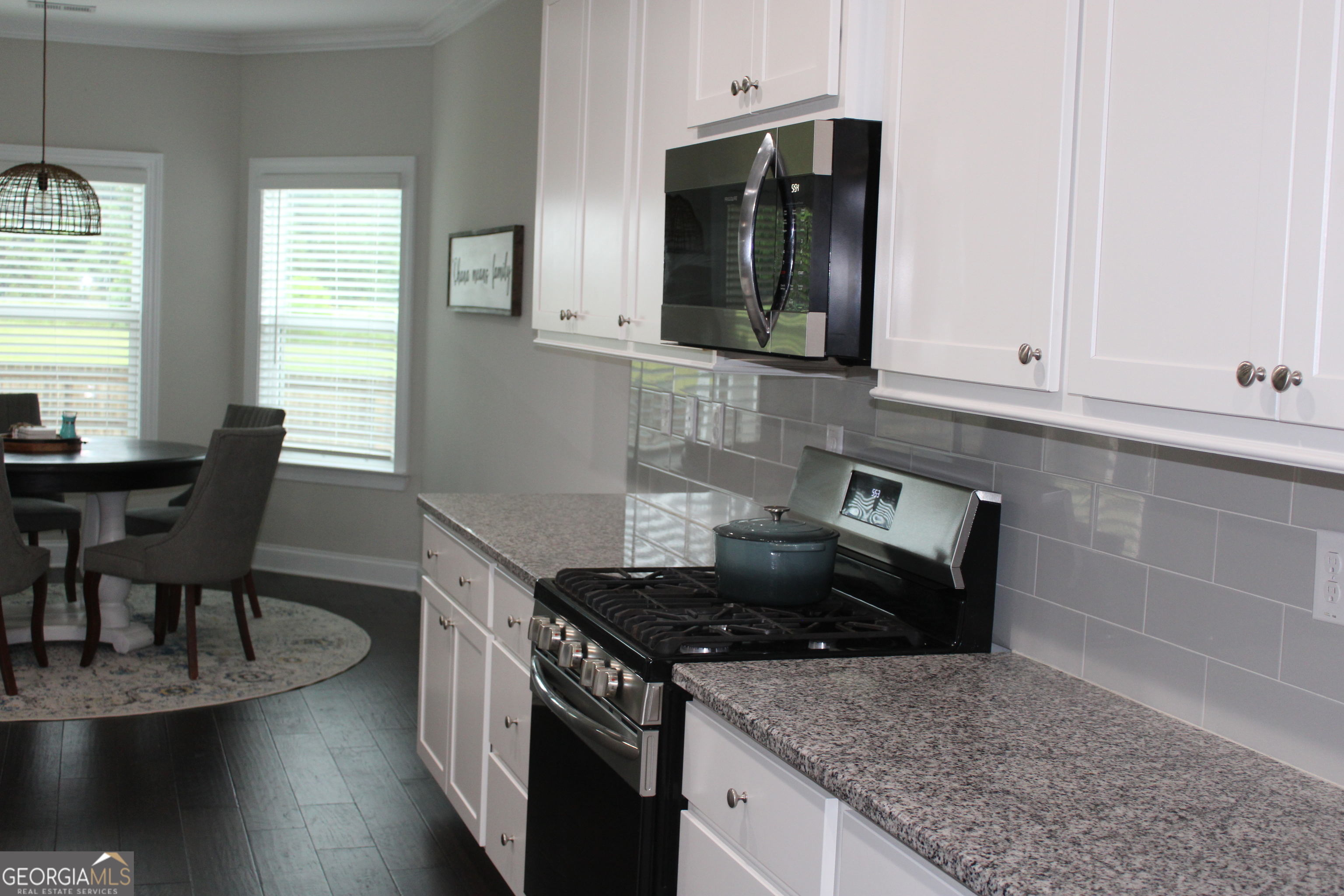 40 Owens Path Senoia, GA 30276 - Photo 7 of 21 a kitchen with granite countertop a stove a sink and a white wooden cabinets