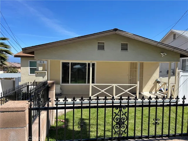 a front view of a house with yard porch and patio