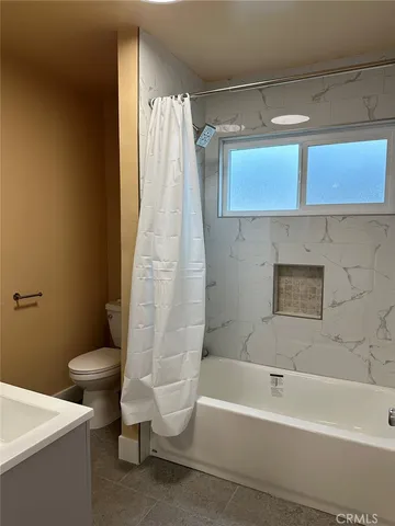 a bathroom with a sink a toilet and bathtub