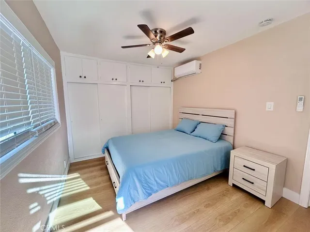 a bedroom with a bed and window