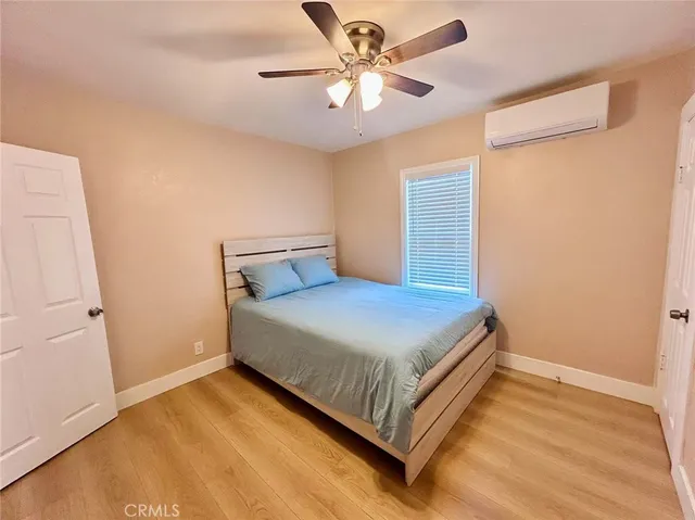 a bedroom with a bed and a ceiling fan