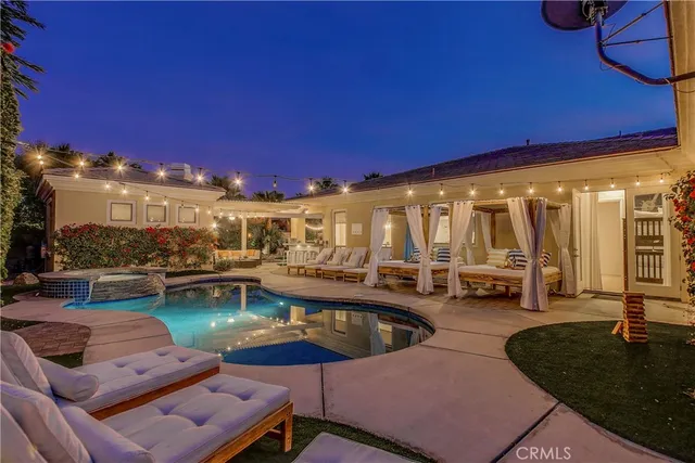 a view of a swimming pool with outdoor seating