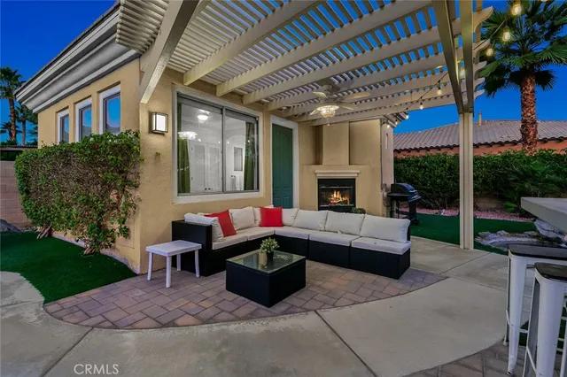a view of a house with backyard porch and sitting area