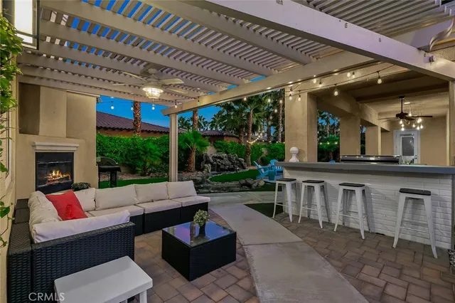a view of a house with backyard porch and sitting area