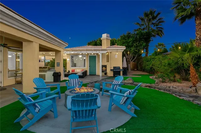 a view of a house with backyard porch and sitting area