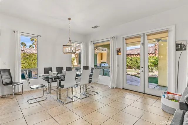 a kitchen with lots of counter top space refrigerator dining table and chairs