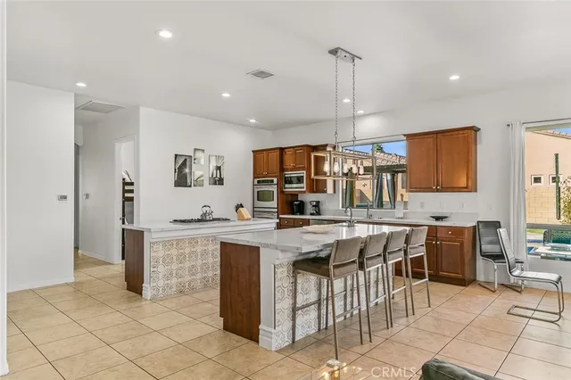 a kitchen with stainless steel appliances granite countertop a sink and stove