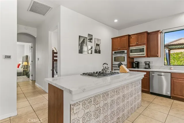 a kitchen with a stove a sink a counter top space and appliances