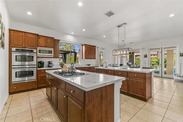 a kitchen with stainless steel appliances granite countertop a sink and a refrigerator