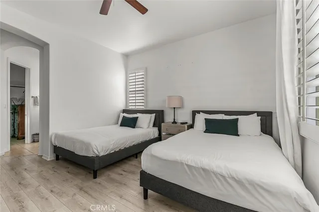 a bedroom with a bed lamp and window