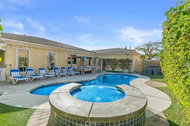a view of a house with swimming pool and furniture