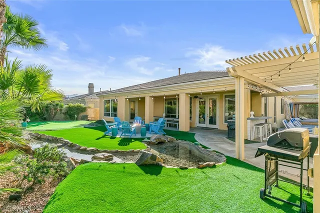 a spacious bedroom with a large bed and a chandelier