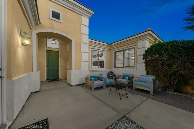 a view of a patio with couches table and chairs with potted plants