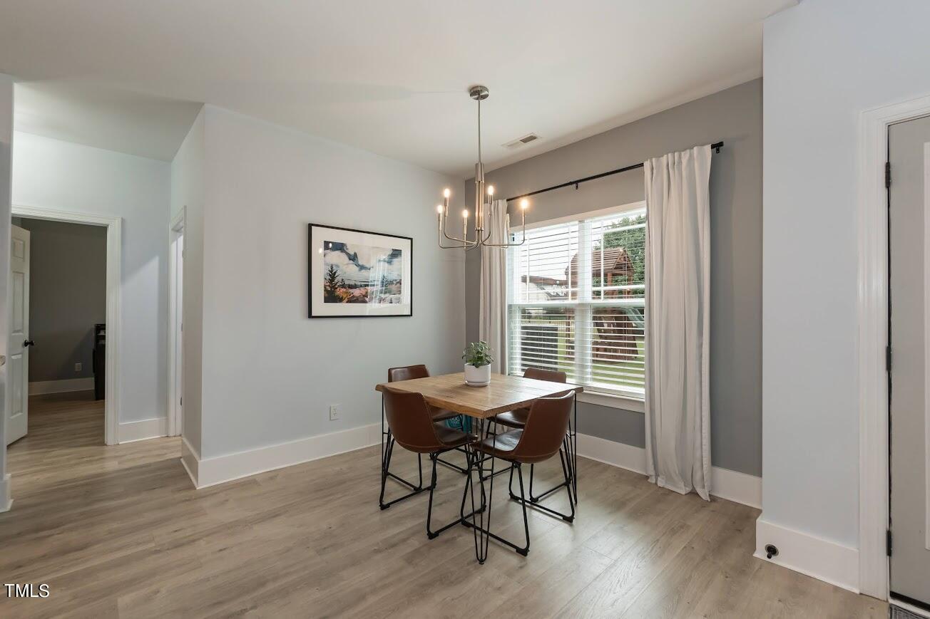 91 Colson Drive Garner, NC 27529 - Photo 16 of 46 a dining room with furniture window wooden floor
