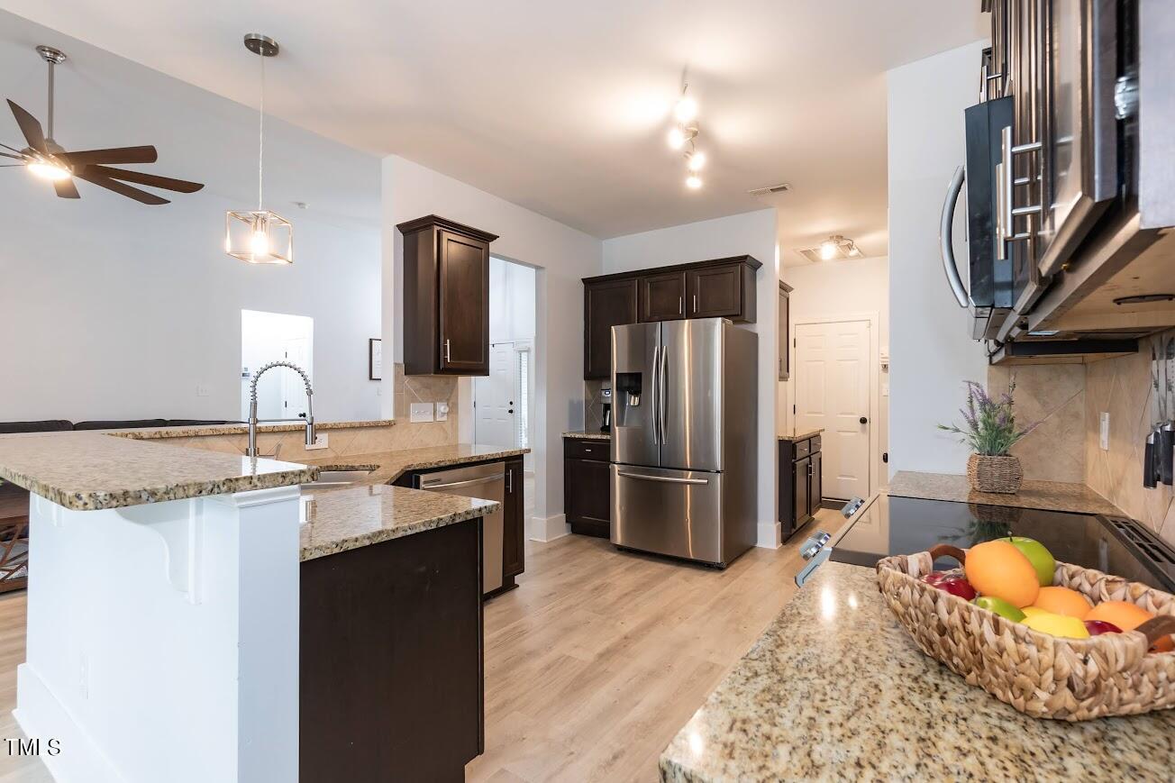 91 Colson Drive Garner, NC 27529 - Photo 19 of 46 a kitchen with stainless steel appliances granite countertop a sink stove and refrigerator