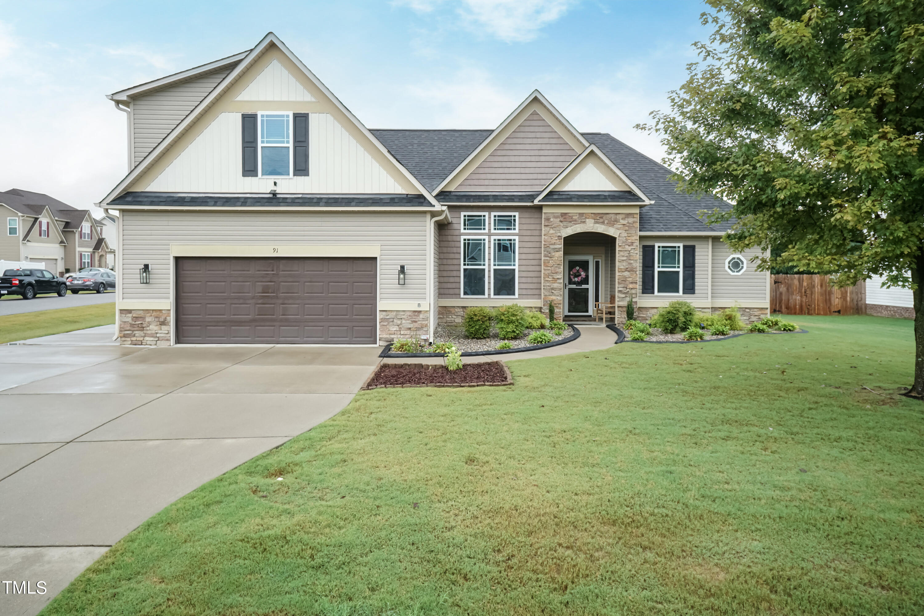 91 Colson Drive Garner, NC 27529 - Photo 2 of 46 a front view of a house with a yard and garage