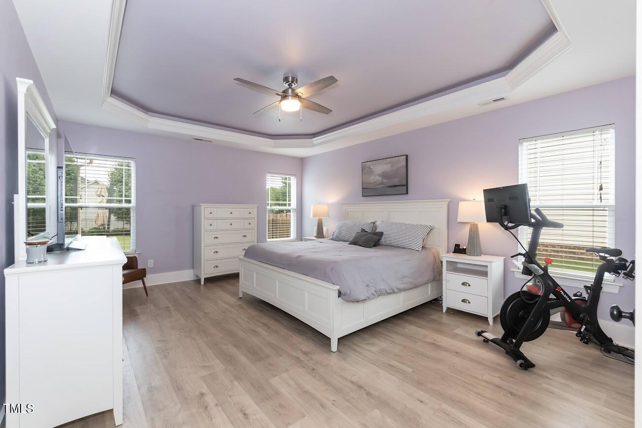 91 Colson Drive Garner, NC 27529 - Photo 24 of 46 a bedroom with a bed and a chandelier