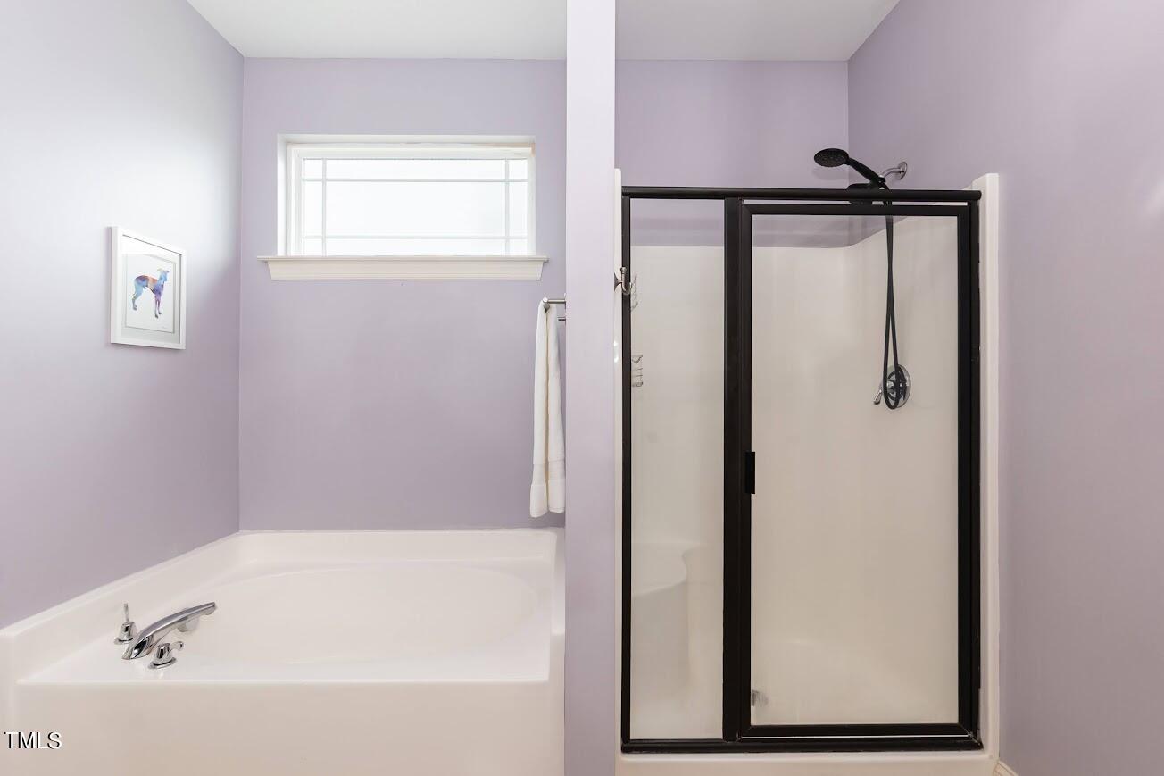 91 Colson Drive Garner, NC 27529 - Photo 28 of 46 a bathroom with a bathtub and a shower