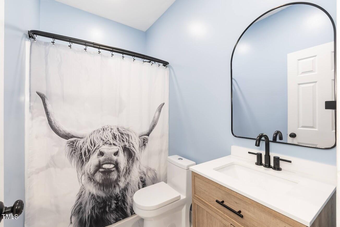 91 Colson Drive Garner, NC 27529 - Photo 30 of 46 a bathroom with a sink toilet and mirror