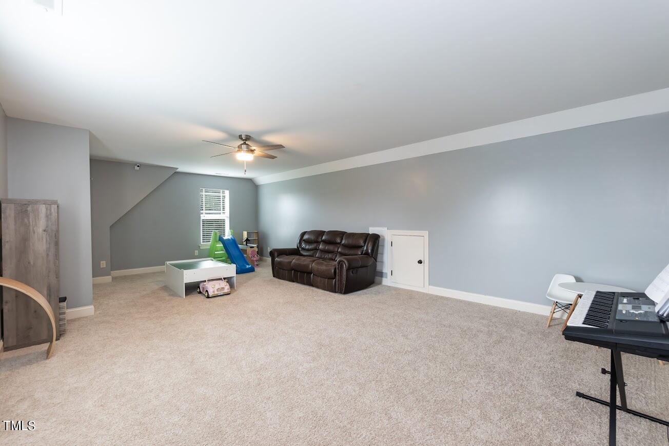 91 Colson Drive Garner, NC 27529 - Photo 33 of 46 a view of a livingroom with furniture and a ceiling fan