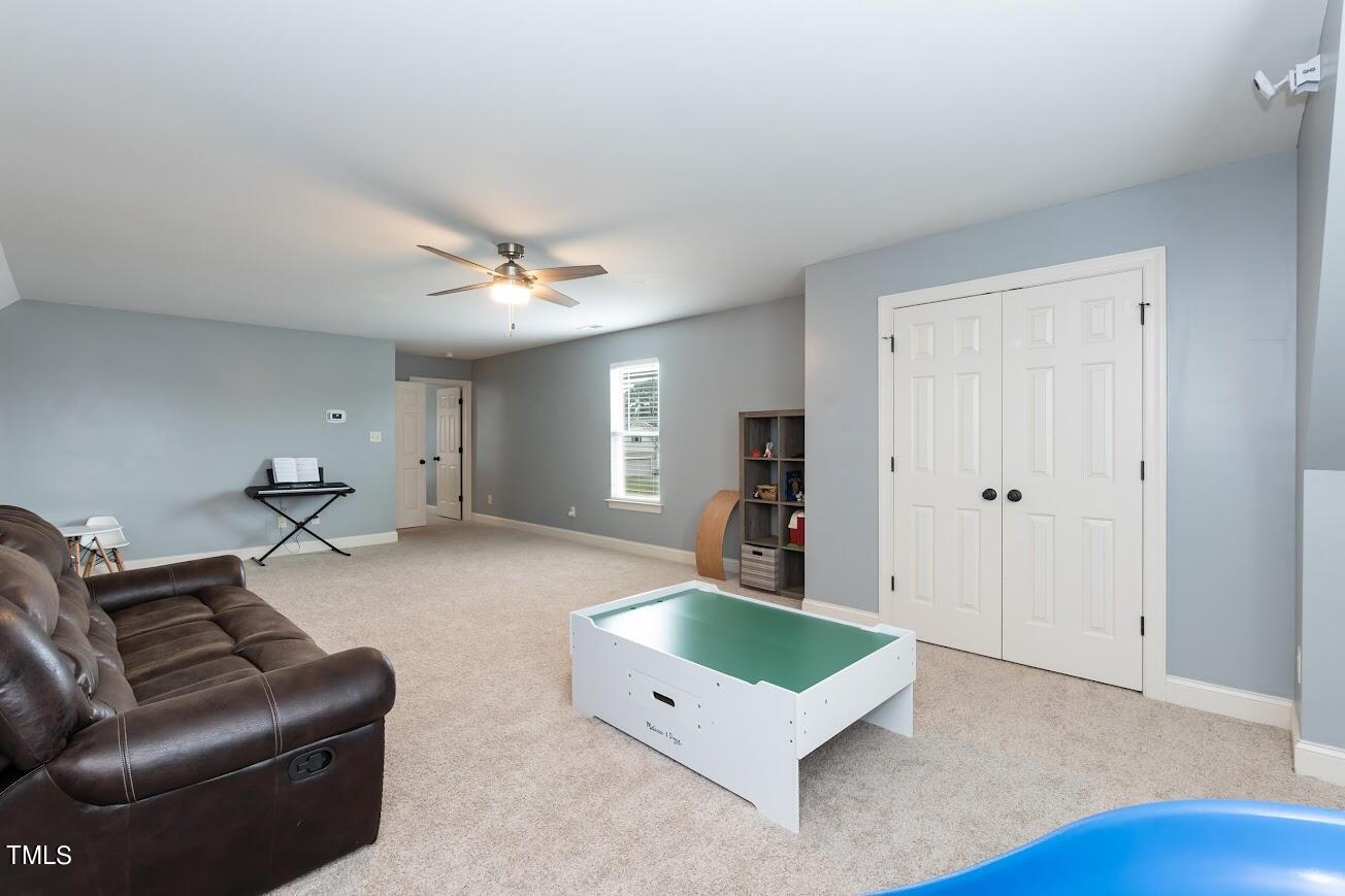 91 Colson Drive Garner, NC 27529 - Photo 34 of 46 a living room with furniture and a ceiling fan
