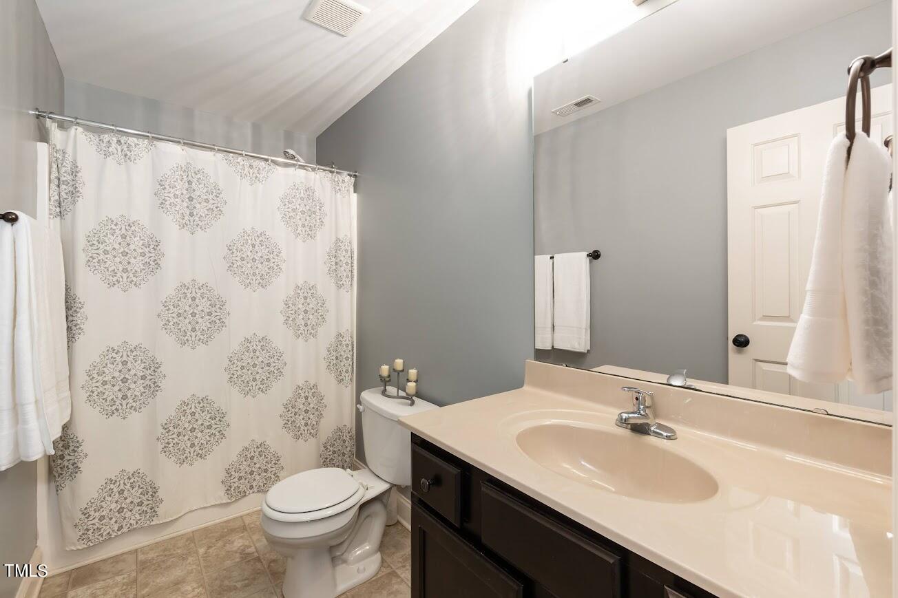 91 Colson Drive Garner, NC 27529 - Photo 35 of 46 a bathroom with a sink and a mirror