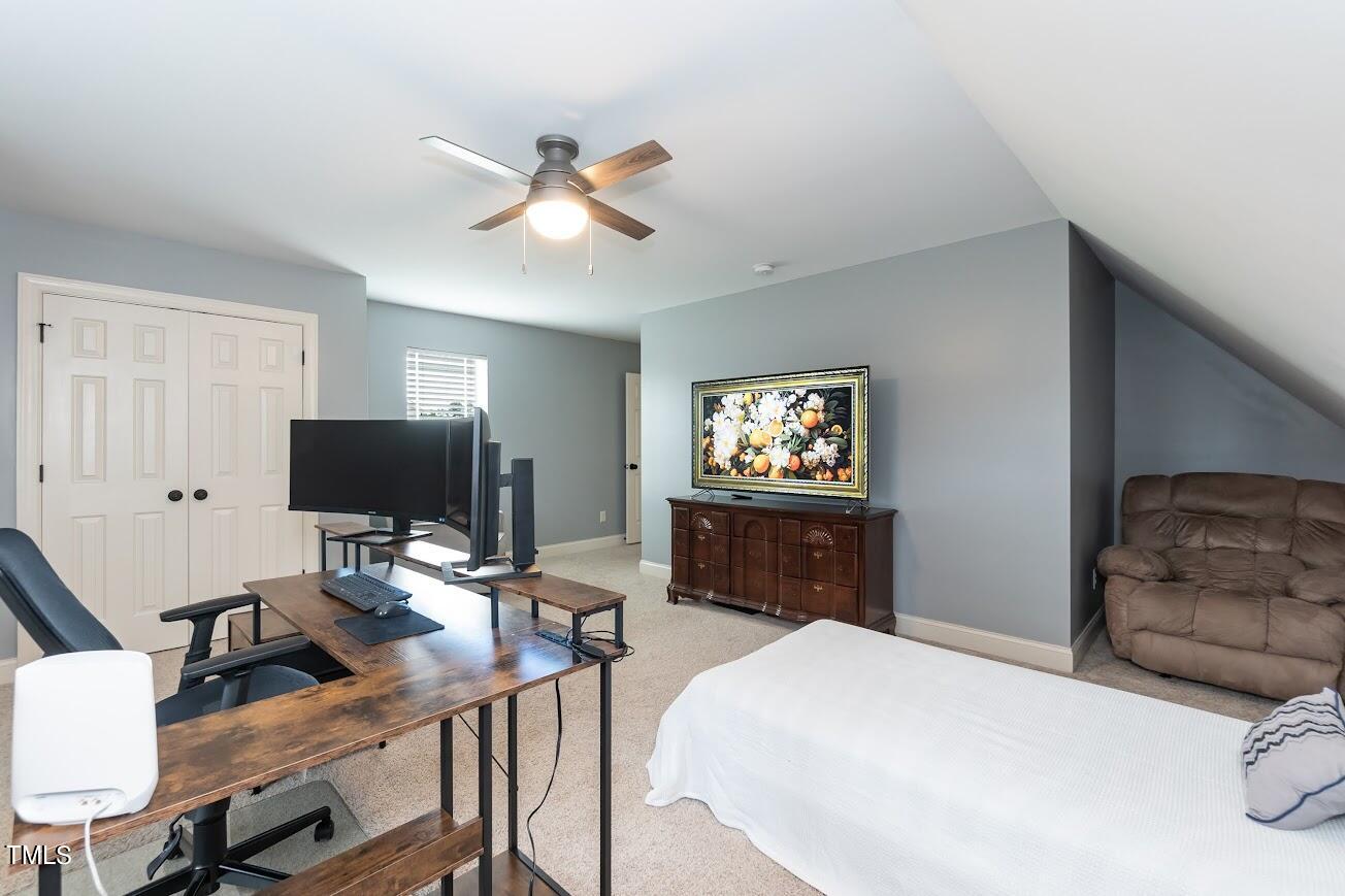 91 Colson Drive Garner, NC 27529 - Photo 37 of 46 a bedroom with a bed and a flat screen tv