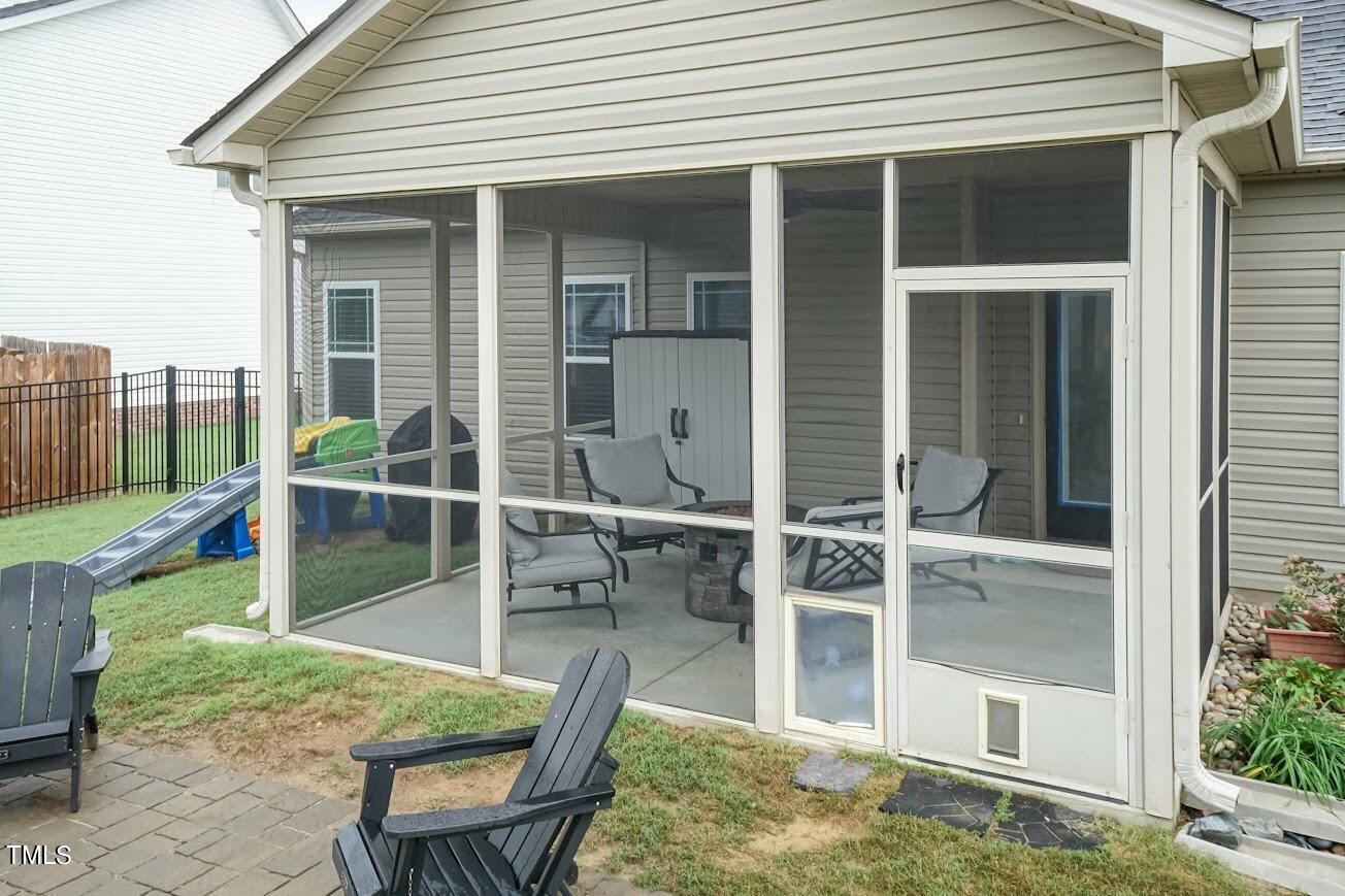 91 Colson Drive Garner, NC 27529 - Photo 39 of 46 front view of house with a chairs and table in the patio