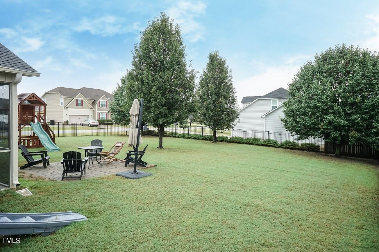 91 Colson Drive Garner, NC 27529 - Photo 44 of 46 a view of a park with swings and slides