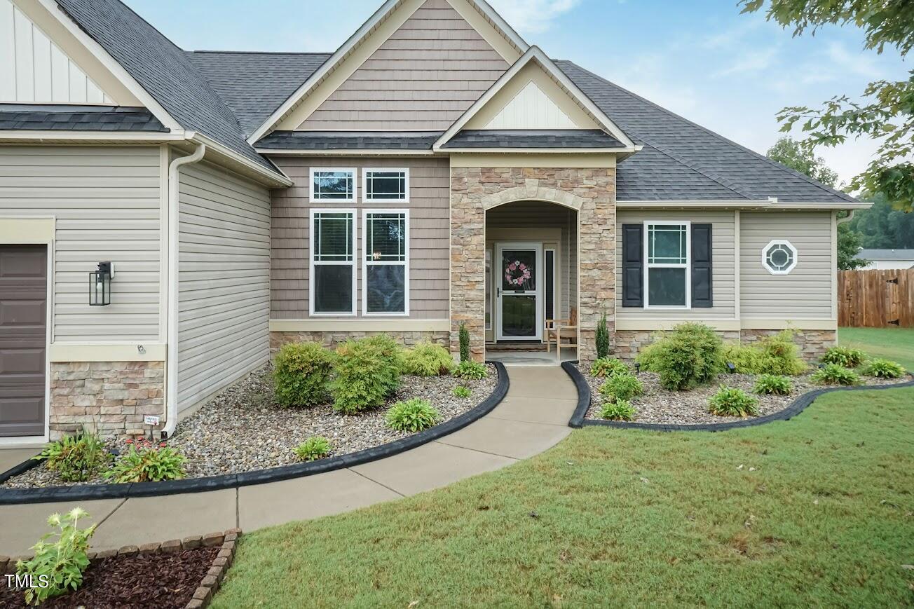 91 Colson Drive Garner, NC 27529 - Photo 6 of 46 a front view of a house with a yard and potted plants