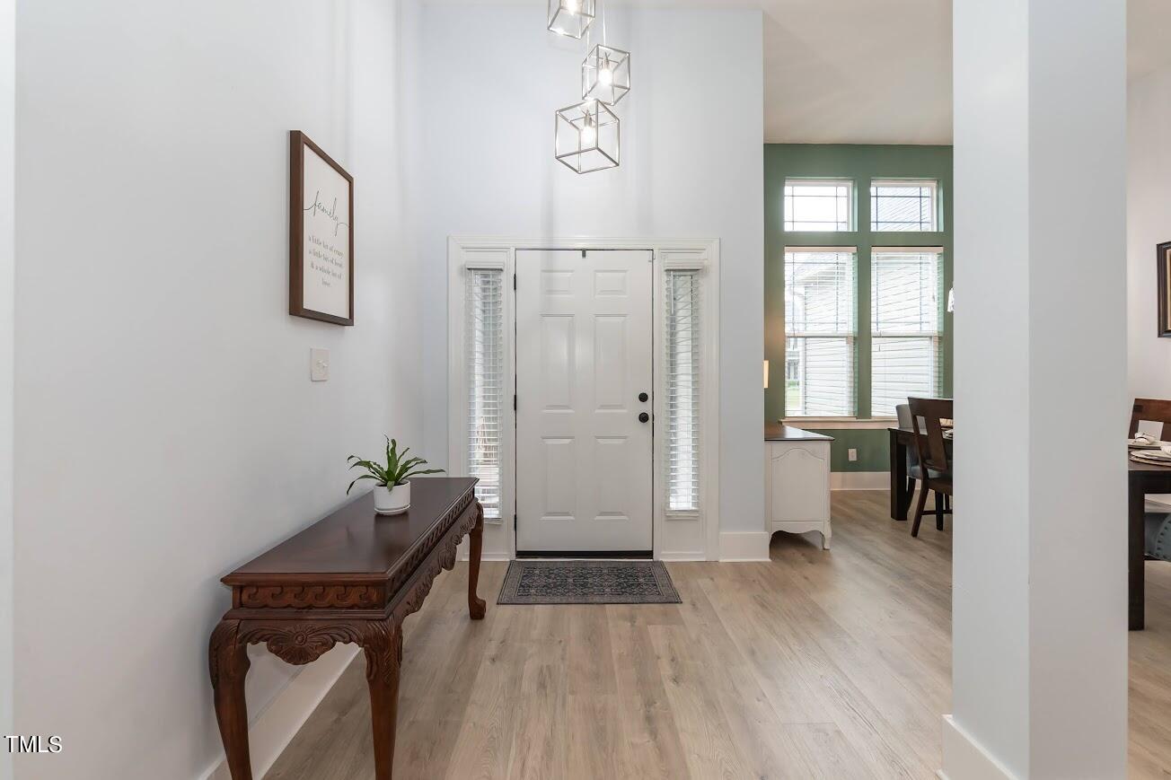 91 Colson Drive Garner, NC 27529 - Photo 9 of 46 a view of a hallway with wooden floor and a bathroom